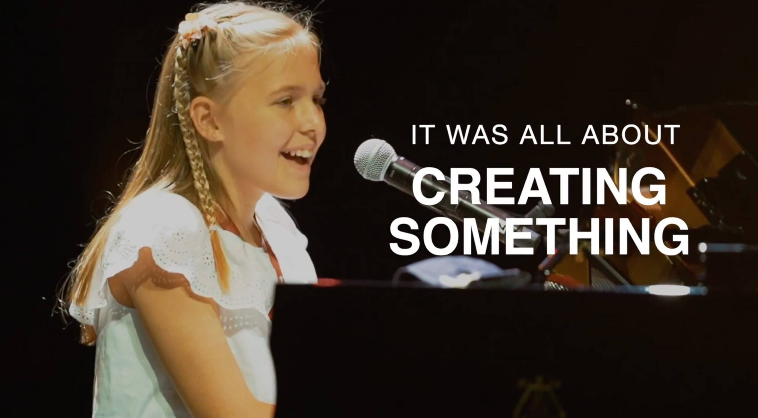 Young girl playing piano and singing